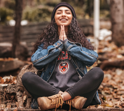 woman sitting cross legged with hands together