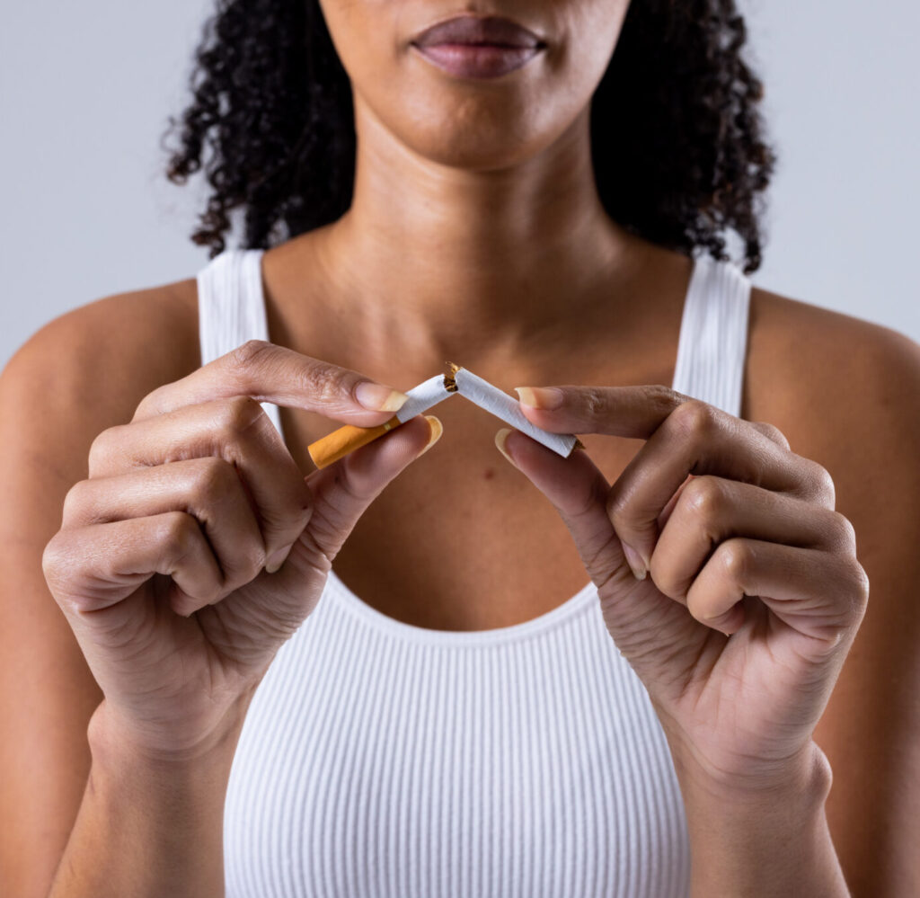 woman breaking a cigarette in half