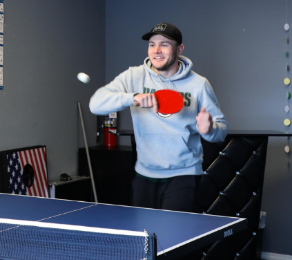 man with red pingpong padel