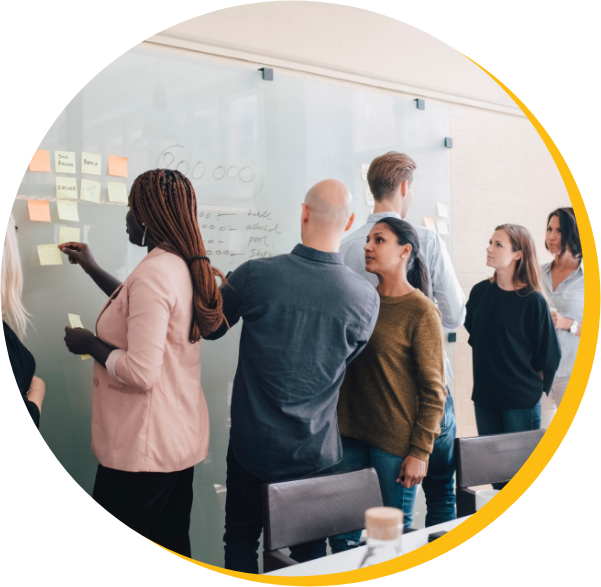 Group in front of a workboard with post it notes